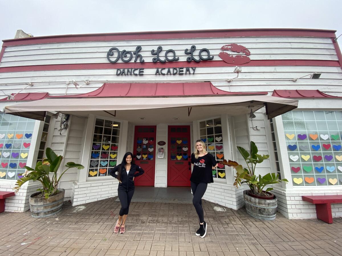 Ooh La La Dance Academy owner Susie Grafte (left) and teacher Brittany Jagoe stand outside the studio in La Jolla, which is currently shut because of mandated coronavirus-related closures. The business also has a location in Pacific Beach.