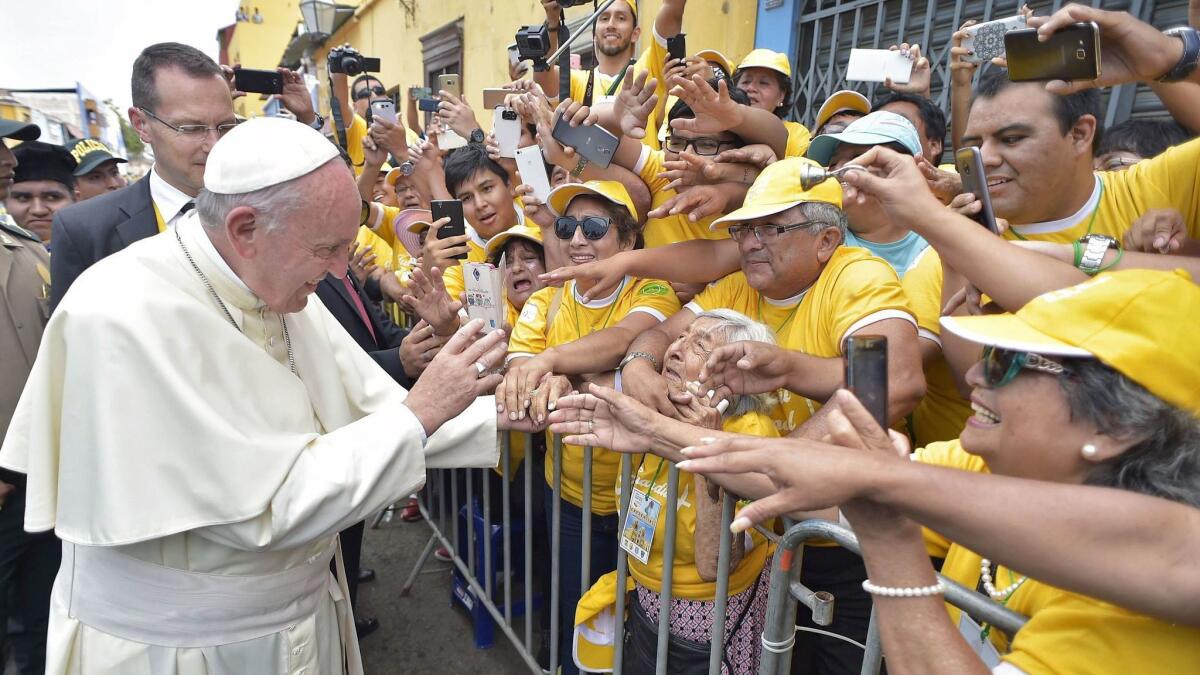 Pope Francis greets crowds in the Peruvian city of Trujillo on Saturday. Despite sometimes controversial comments, he remains hugely popular in South America.
