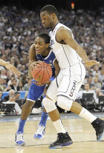 During first-half action at Reliant Stadium in Houston, Kentucky freshman guard Brandon Knight squeezes by UConn junior guard Kemba Walker. The UConn Huskies lead Kentucky 31-21at halftime in the Final Four national semifinal game.