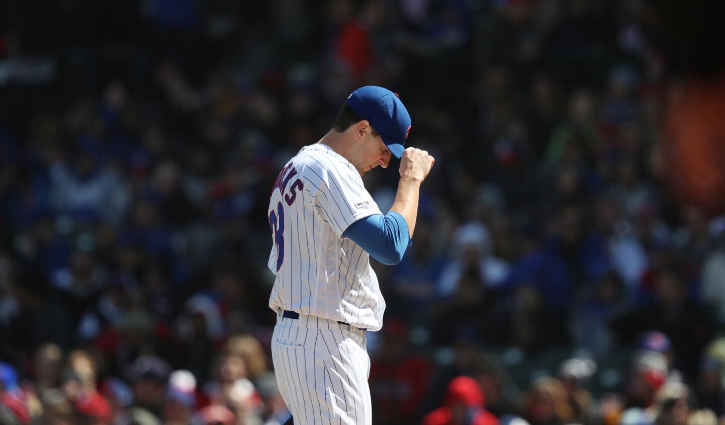 Cubs starting pitcher Kyle Hendricks adjusts his cap after loading the bases in the second inning against the Angels at Wrigley Field on April 13, 2019.