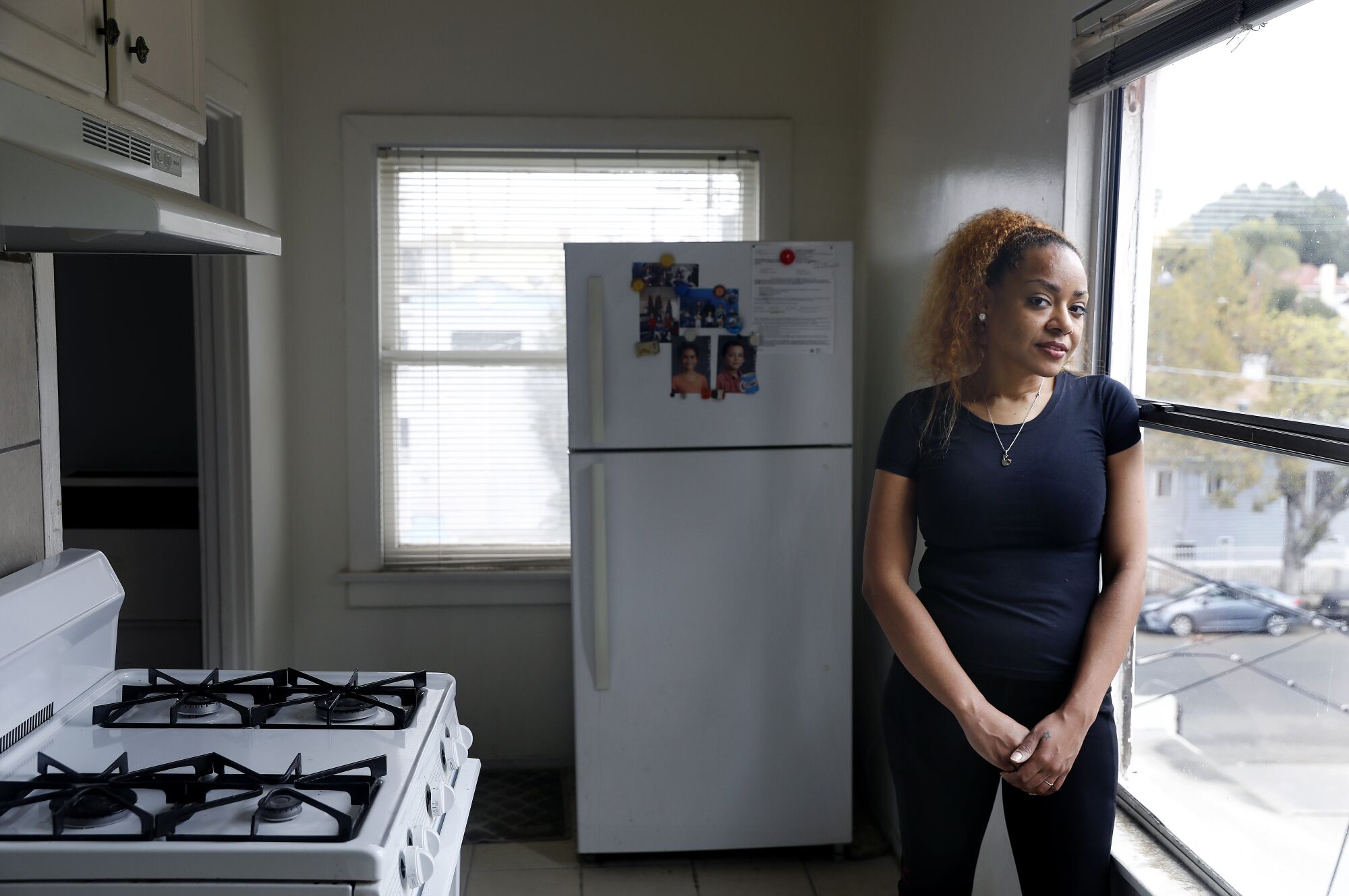Leticia Graham stands in her apartment's kitchen.