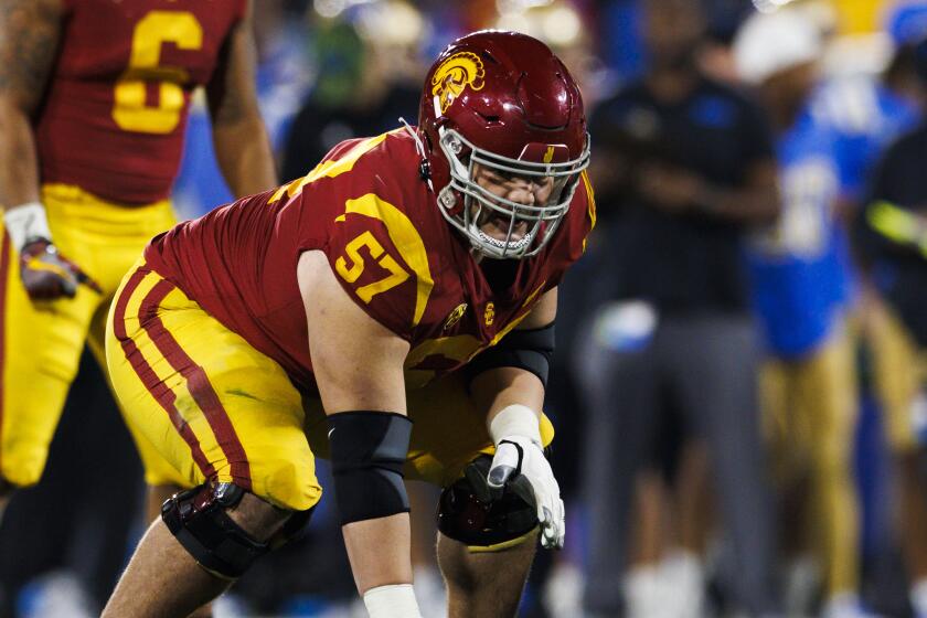 PASADENA, CA - NOVEMBER 19: USC Trojans offensive lineman Justin Dedich (57) in an offensive stance.