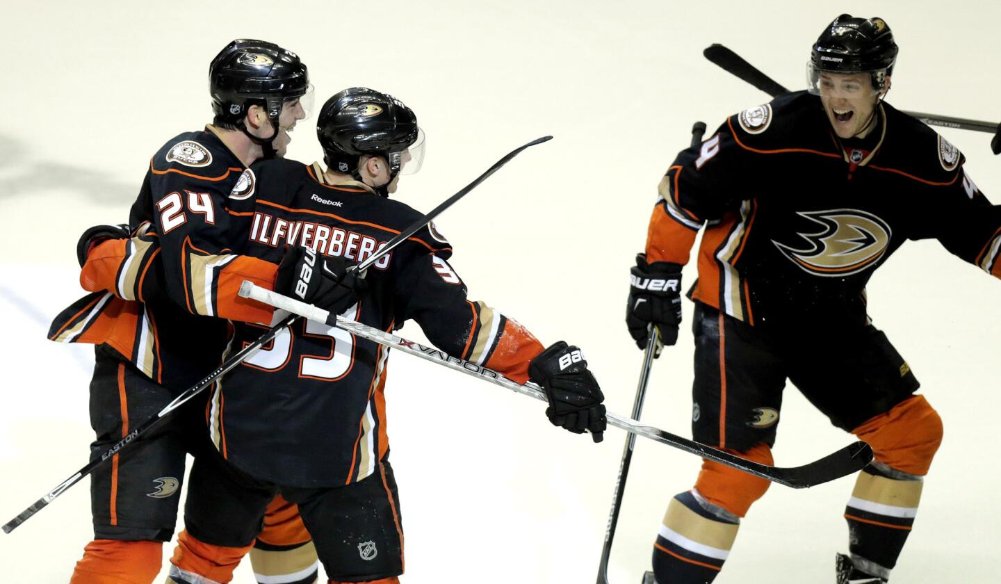 Ducks right wing Jakob Silfverberg (33) is congratulated by defenseman Simon Despres (24) and Cam Forwler, right, after scoring the game-winning goal against the Jets in Game 2.