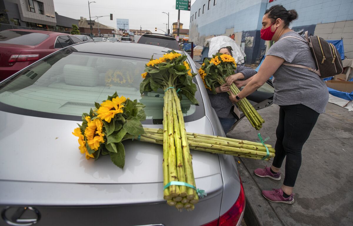 Women put flowers in car