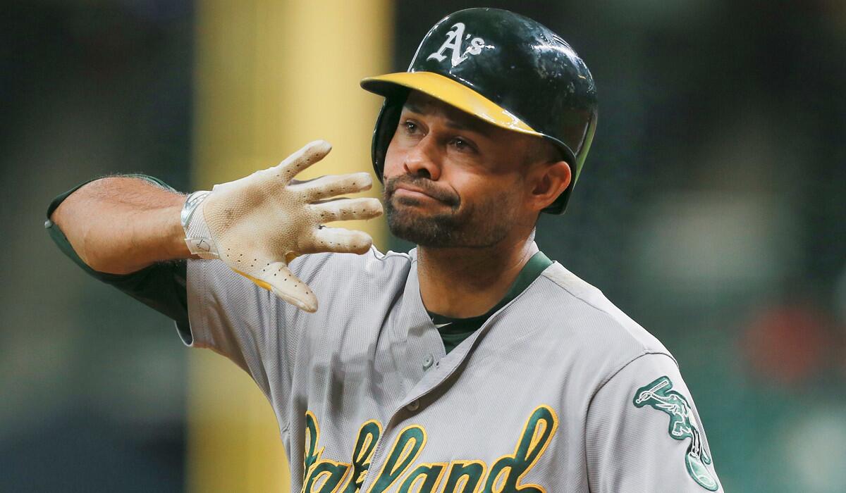Oakland Athletics' Coco Crisp disagrees with the third base umpire's decision that he didn't check his swing for strike three in the first inning against the Houston Astros Monday.