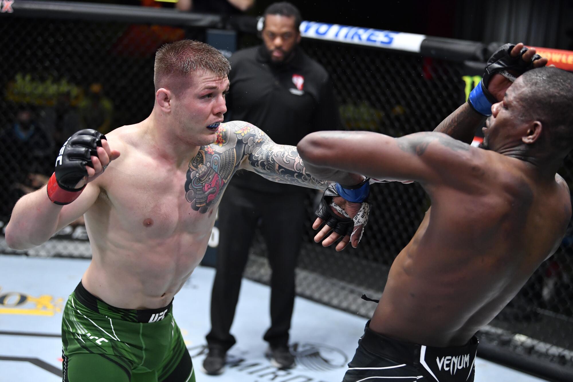 LAS VEGAS, NEVADA - APRIL 10: (L-R) Marvin Vettori of Italy punches Kevin Holland.