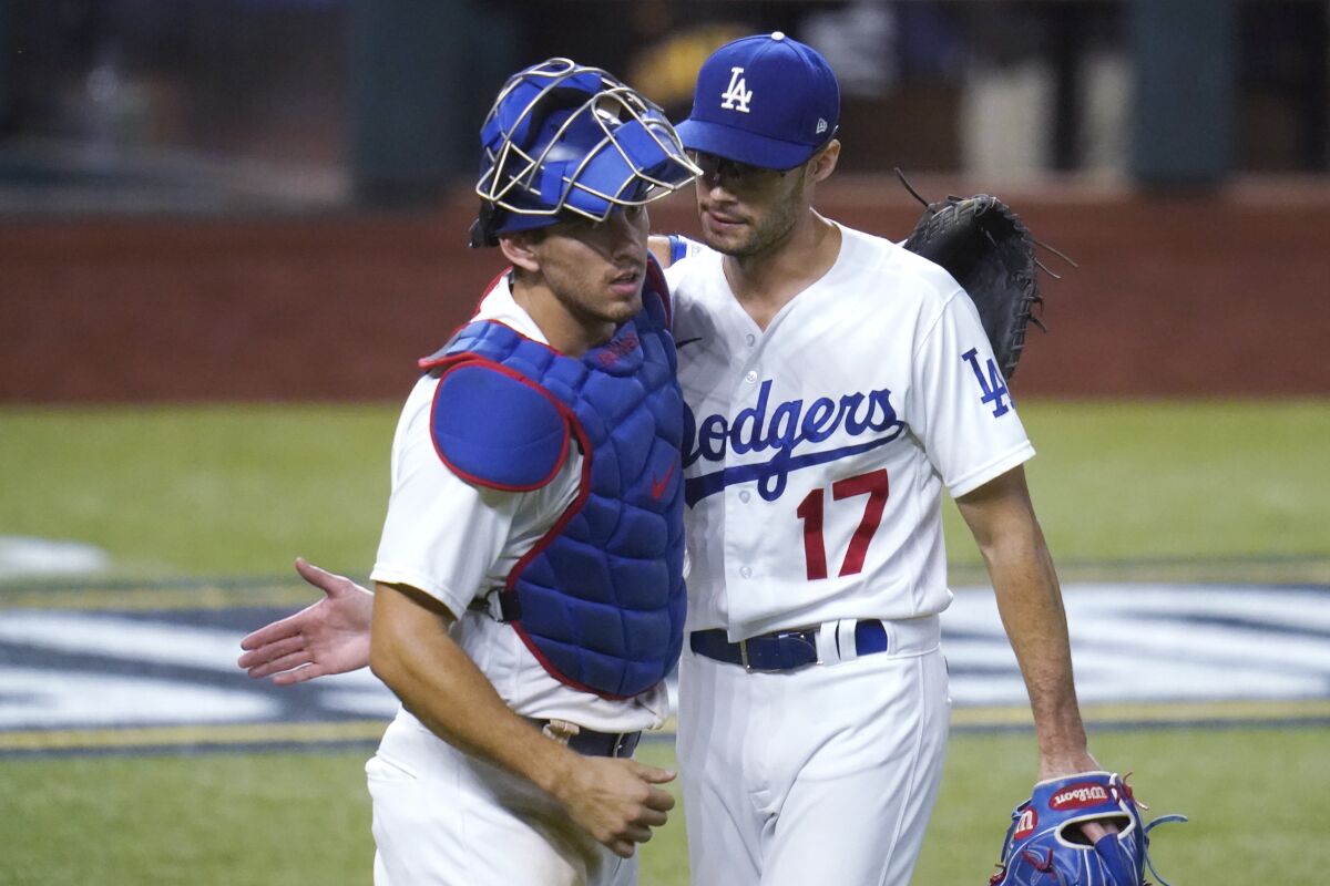 Dodgers catcher Austin Barnes and reliever Joe Kelly celebrate a win over the San Diego Padres.