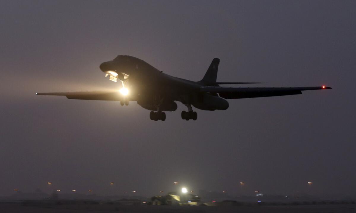 A B-1 bomber prepares to land at Al Udeid Air Base in Qatar. Since deploying to the base last summer, U.S. airmen have upgraded 2,000 free-falling bombs to "smart bomb" status.