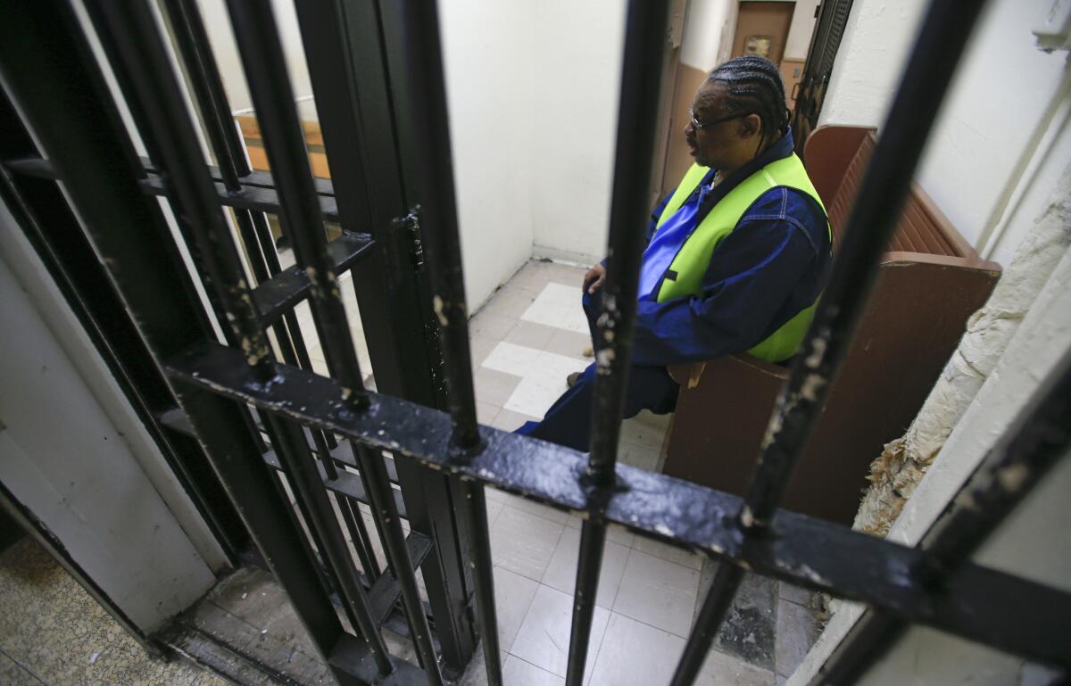 A prisoner waits inside a holding cell to attend a parole board hearing at San Quentin State Prison. Gov. Jerry Brown's ballot Proposition 57 would offer new chances at parole for some inmates, and additional good behavior credits for others. (Mark Boster / Los Angeles Times)