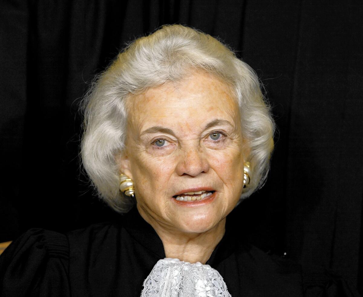 Supreme Court Associate Justice Sandra Day O'Connor poses during a group portrait session with the members of the U.S. Supreme Court, at the Supreme Court Building in Washington, Friday, Dec. 05, 2003.