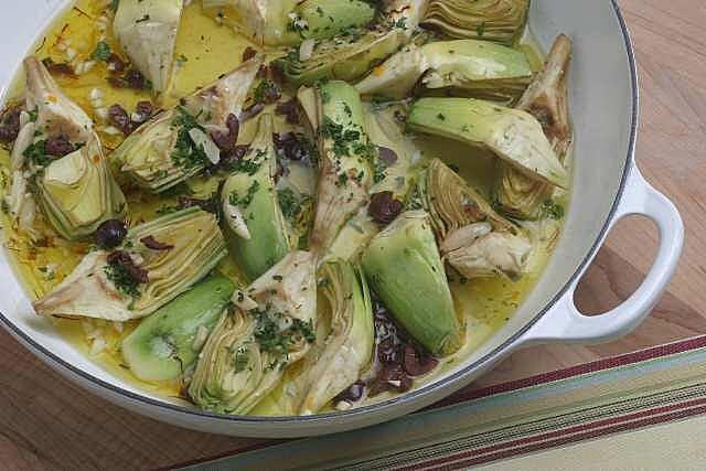 Artichokes braised with saffron, black olives and almonds