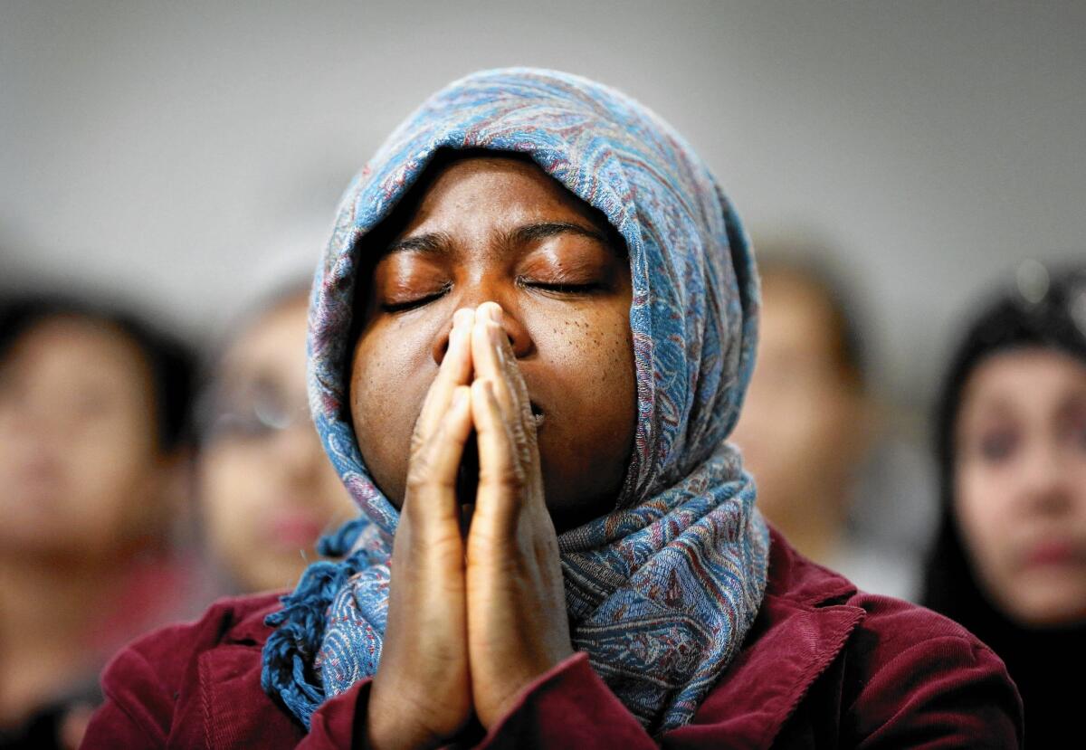 Ajarat Bada, a nurse, prays during a service Sunday at the Islamic Community Center of Redlands in Loma Linda to remember the victims of the San Bernardino rampage.