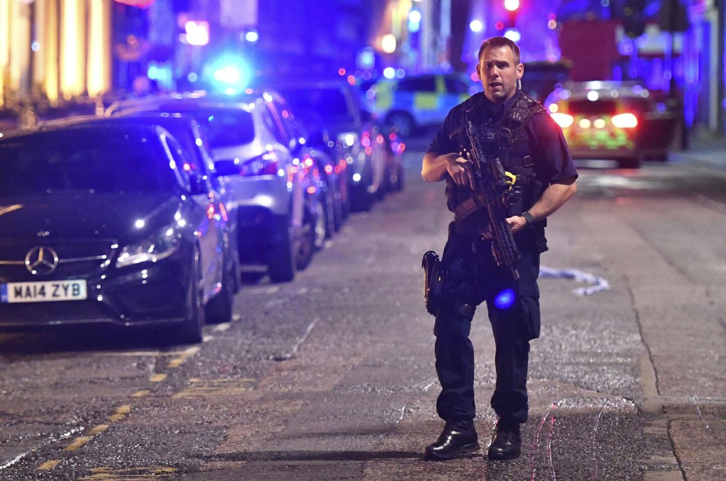 An armed police officer stands on Borough High Streetin London after the attack.