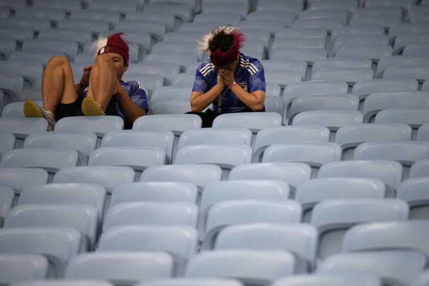 Fans of Japan react after Croatia won in the World Cup round of 16 soccer match between Japan and Croatia at the Al Janoub Stadium in Al Wakrah, Qatar, Monday, Dec. 5, 2022. (AP Photo/Eugene Hoshiko)