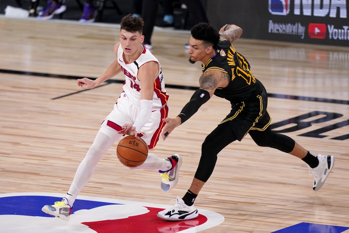 Miami Heat's Tyler Herro, left, and Los Angeles Lakers' Danny Green, right, compete for control of a loose ball during the second half of Game 2 of basketball's NBA Finals, Friday, Oct. 2, 2020, in Lake Buena Vista, Fla. (AP Photo/Mark J. Terrill)