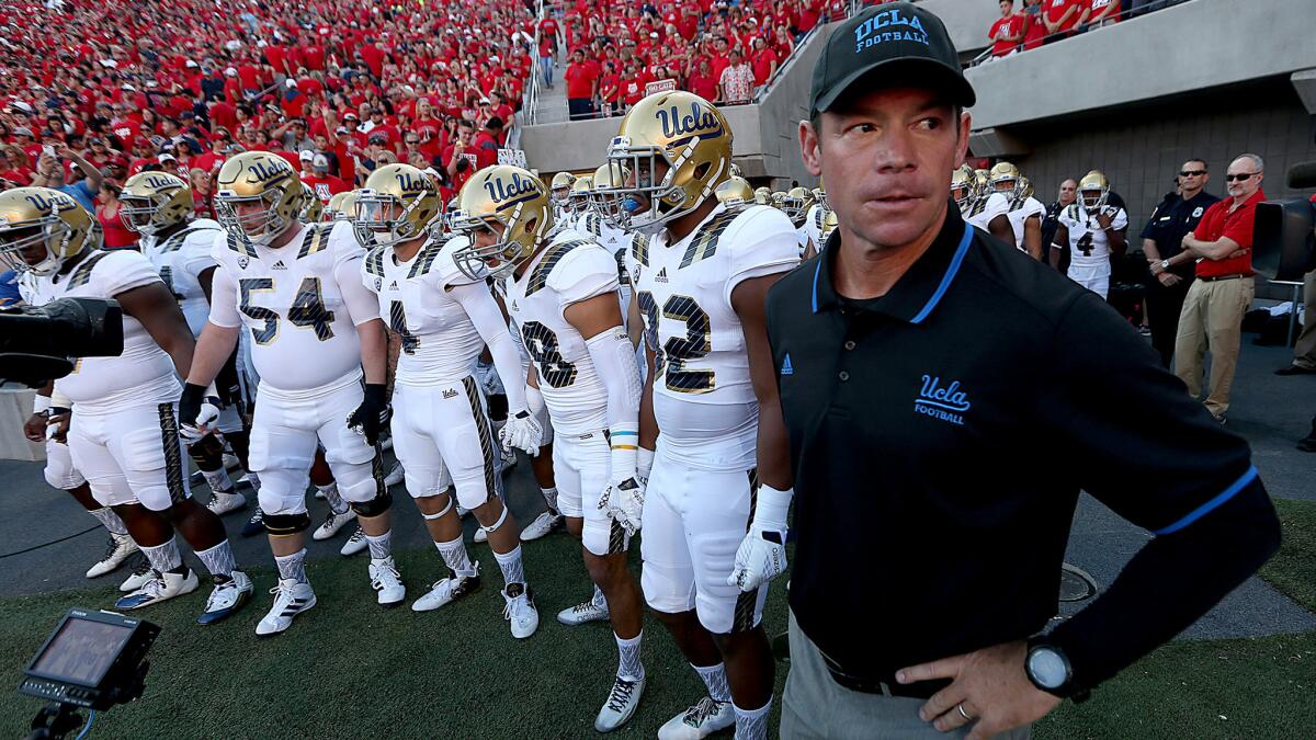 UCLA Coach Jim Mora and the Bruins get ready to take the field against Arizona on Saturday night in Tucson.