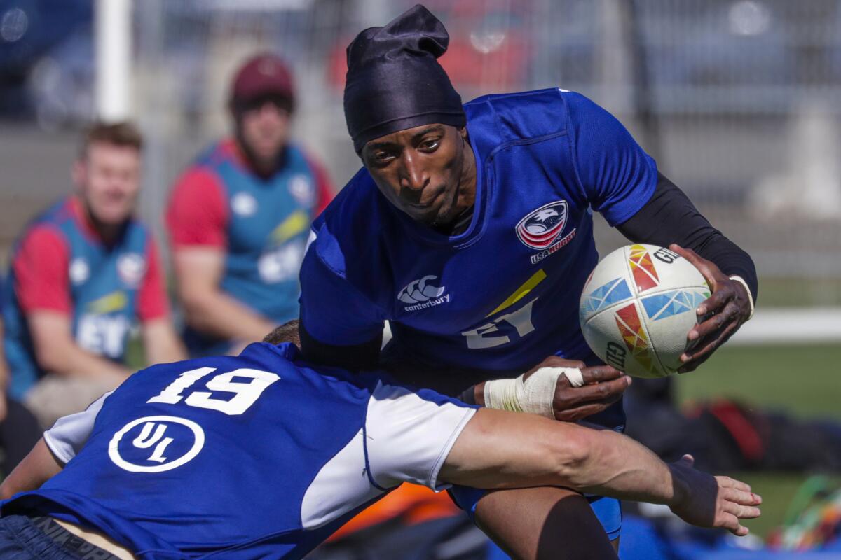 Perry Baker tries to evade a defender during a U.S. rugby sevens practice on Feb. 26, 2020, at Dignity Health Sports Park in Carson.