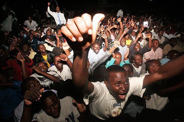 Kenyans gathered en masse to watch the inauguration of Barack Obama as the 44th U.S. president. Here, the crowd reacts to scenes appearing on a large TV screen in Nairobi.