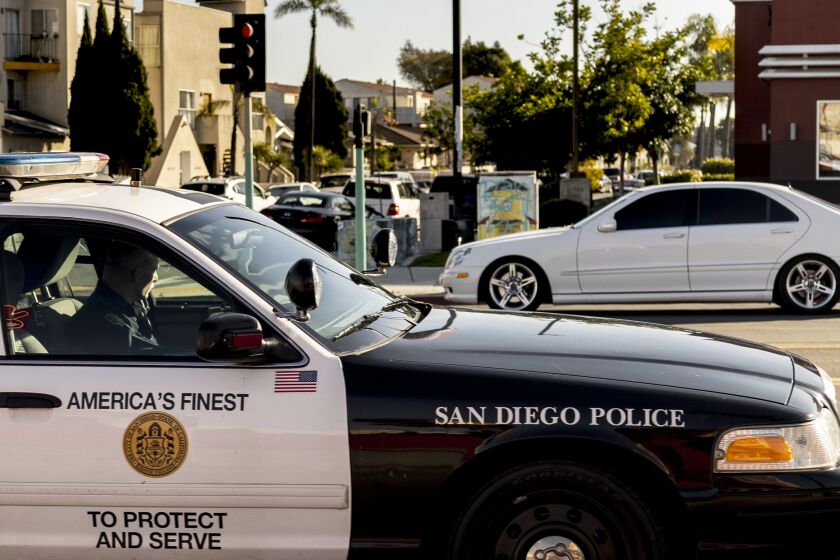 San Diego, CA - January 06: A San Diego Police Department officer patrols along El Cajon Boulevard near Hoover High School on Thursday, Jan. 6, 2022 in San Diego, CA. (Sam Hodgson / The San Diego Union-Tribune)