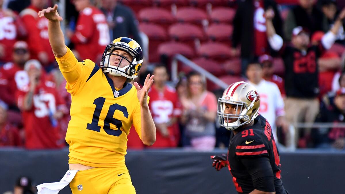 Rams quarterback Jared Goff completes a pass while under pressure from 49ers defensive lineman Arik Armstead during a Rams' 41-39 win last Thursday.
