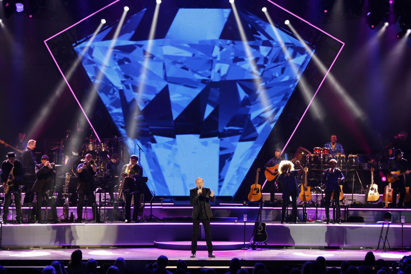 Singer Neil Diamond, with a not-so-subtle image in the background depicting his surname, performs at the Hollywood Bowl on Saturday night.
