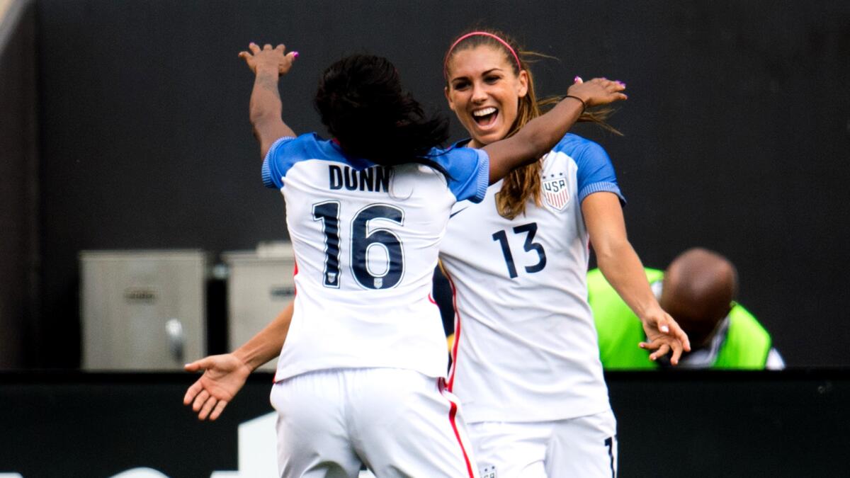 Alex Morgan (13) celebrates her goal with teammate Crystal Dunn during a 2-0 victory over Japan on Sunday.