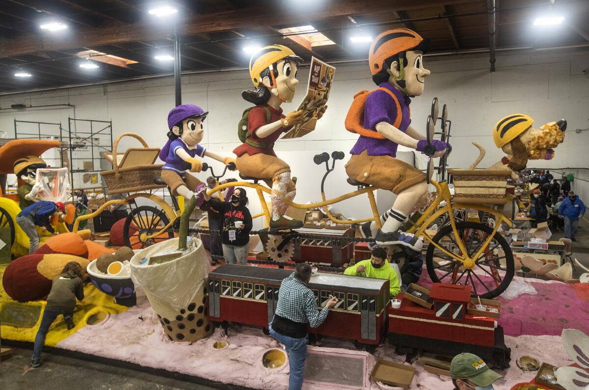 Volunteers work on the China Airlines float with the theme "Biking Around Taiwan"