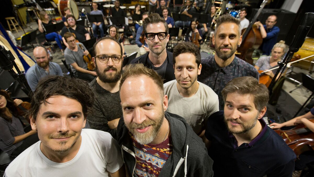 The Echo Society pauses during a rehearsal for its annual concert. Front row, from left: Brendan Angelides, Nathan Johnson, Judson Crane. Back row, from left: Joseph Trapanese, Benjamin Wynn, Jeremy Zuckerman and Rob Simonsen.
