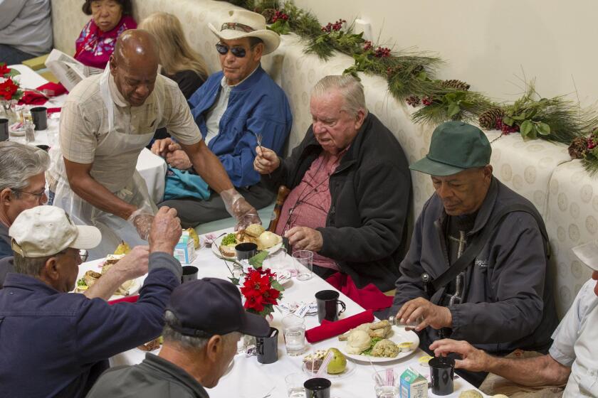 John Gibbins  U-t Serving Seniors is 46th in the small companies category. Above, a volunteer serves Christmas dinner at its downtown San Diego facility in 2017.