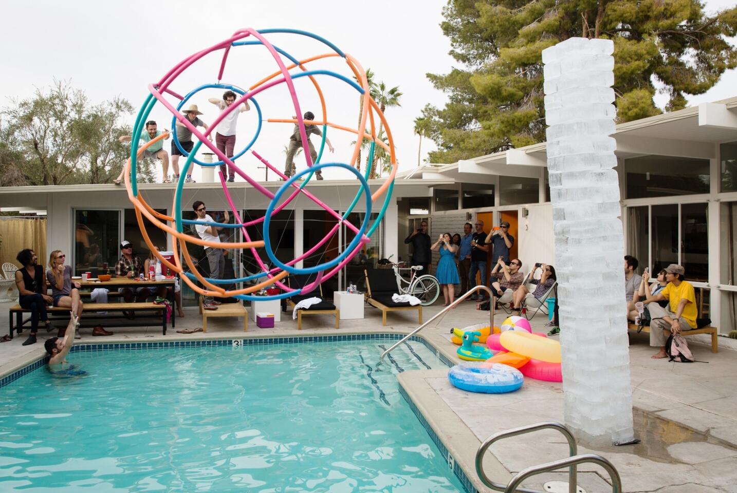 "Deep End," a wire-frame beach ball, launches into the pool at the Amado hotel in Palm Springs. A reinvention of Allan Kaprow's 1967 "Fluids" installation is at right.