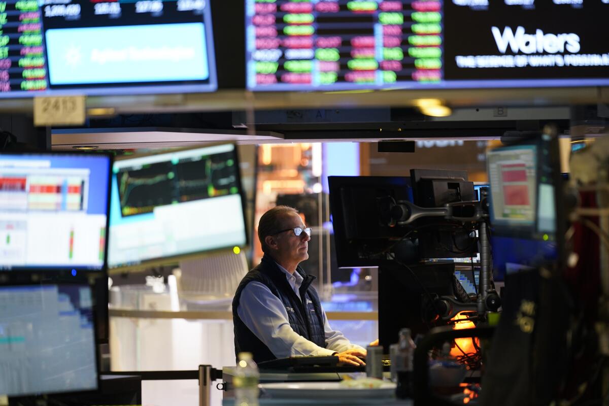 Traders work on the floor at the New York Stock Exchange in New York