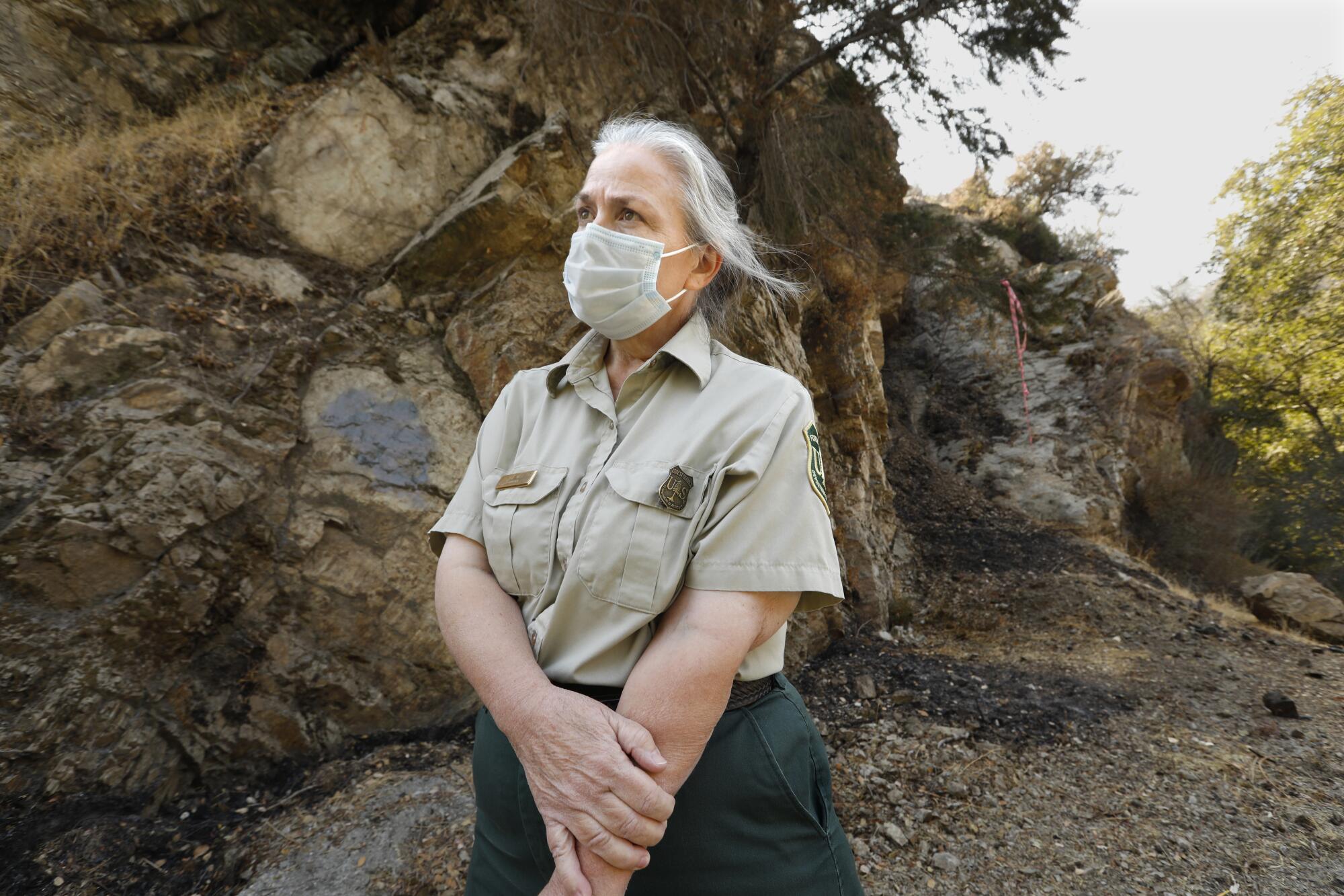 U.S. Forest Service biologist Leslie Welch surveys damage from the Bobcat fire in the San Gabriel Mountains