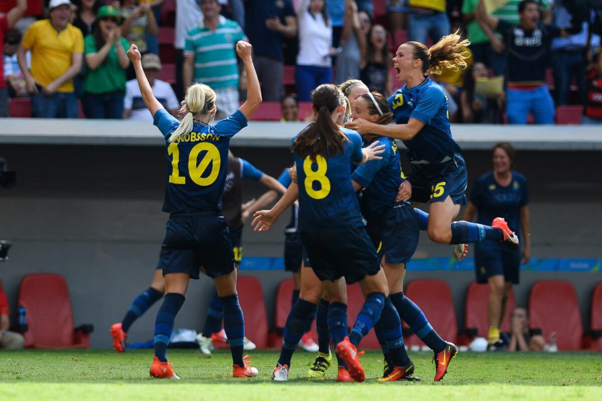 Swedish players celebrate a goal against the U.S. during their quarterfinal match at the Mane Garrincha Stadium in Brasilia on Aug. 12.