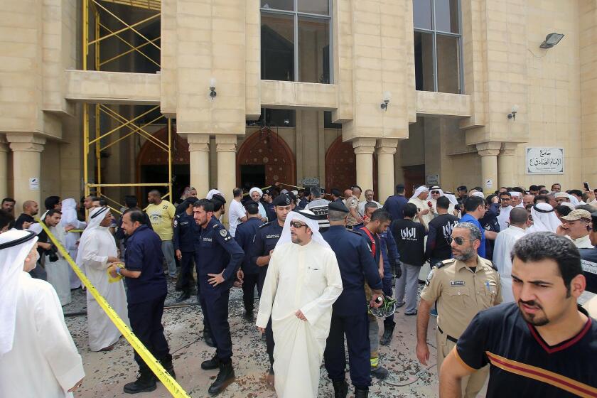 Kuwaiti security forces gather outside the Shiite Imam Sadeq mosque after it was targeted by a suicide bombing during Friday prayers on June 26, 2015, in Kuwait City.