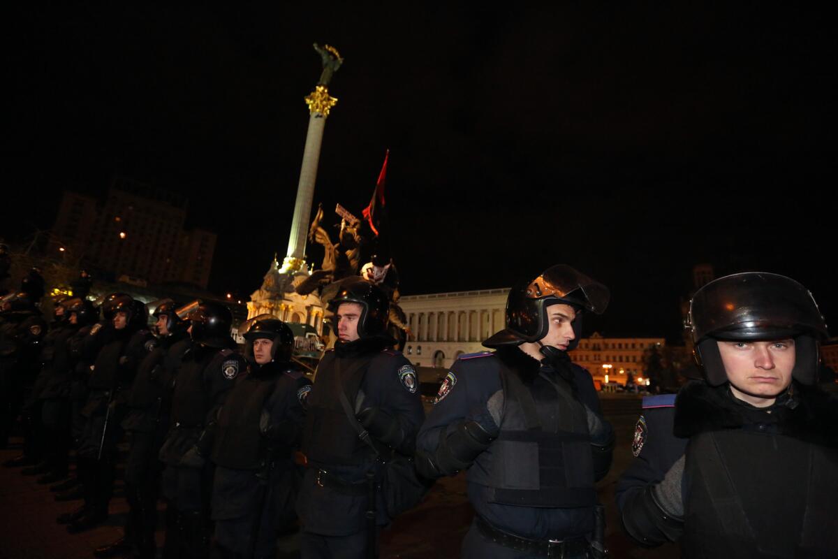 Police surround Independence Square in downtown Kiev, the Ukrainian capital, early Saturday. A monument to Ukraine's independence is in the background.