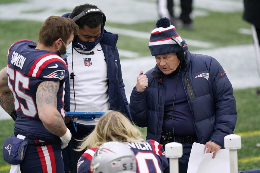 New England Patriots head coach Bill Belichick, right, instructs defensive lineman Chase Winovich, center, as inside linebackers coach Jerod Mayo, second from left, instructs defensive end John Simon, left, on the sideline in the first half of an NFL football game against the New York Jets, Sunday, Jan. 3, 2021, in Foxborough, Mass. (AP Photo/Elise Amendola)