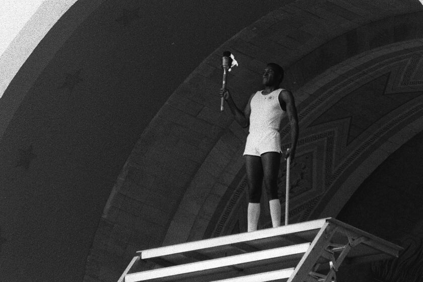 7/28/1984  OLY LEGACY  Rafer Johnson lights the Olympic Flame at the Los Angeles Coliseum. FOR OLYMPIC LEGACY STORY BY ALAN ABRAHAMSON