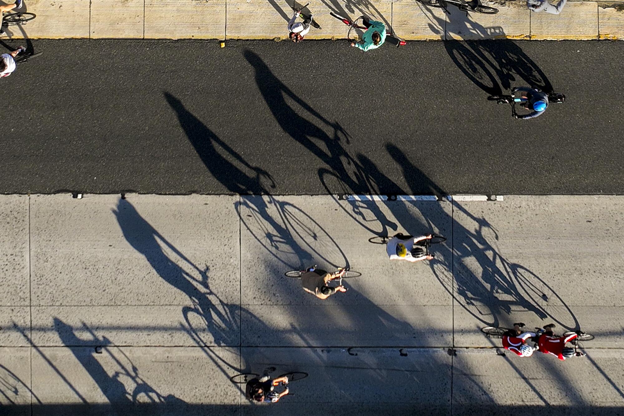 An aerial view of early morning light casting shadows of bicyclists taking part in ArroyoFest.