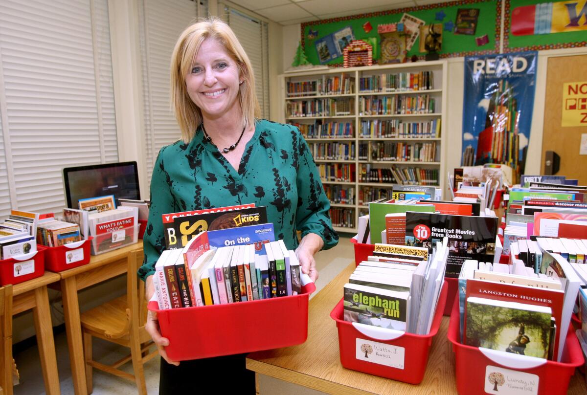 Former Luther Burbank Middle School teacher and National Teacher of the Year Rebecca Mielwocki shows some of the $5,000 worth of books she donated, through Scholastic, to her former school in Burbank on Tuesday, Sept. 29, 2015. About 1,000 common core curriculum books were dived up for the 47 teachers and counselors on campus. Mielwocki is currently coordinator of secondary induction for the Burbank School District.