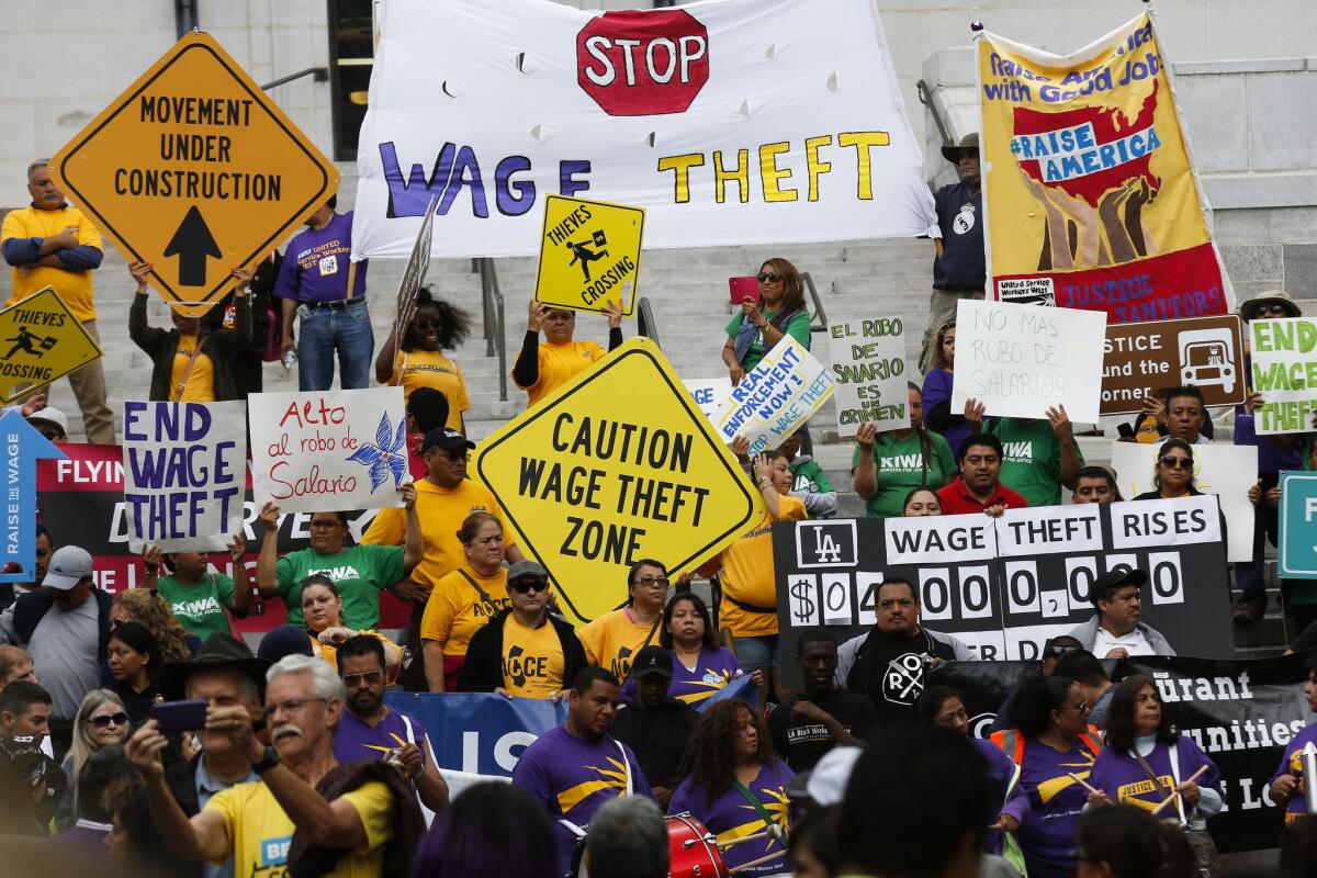 Low-wage garment, car wash, restaurant and other workers outside Los Angeles City Hall in 2015 urged city leaders to form an anti-wage theft bureau and adopt strong enforcement measures.