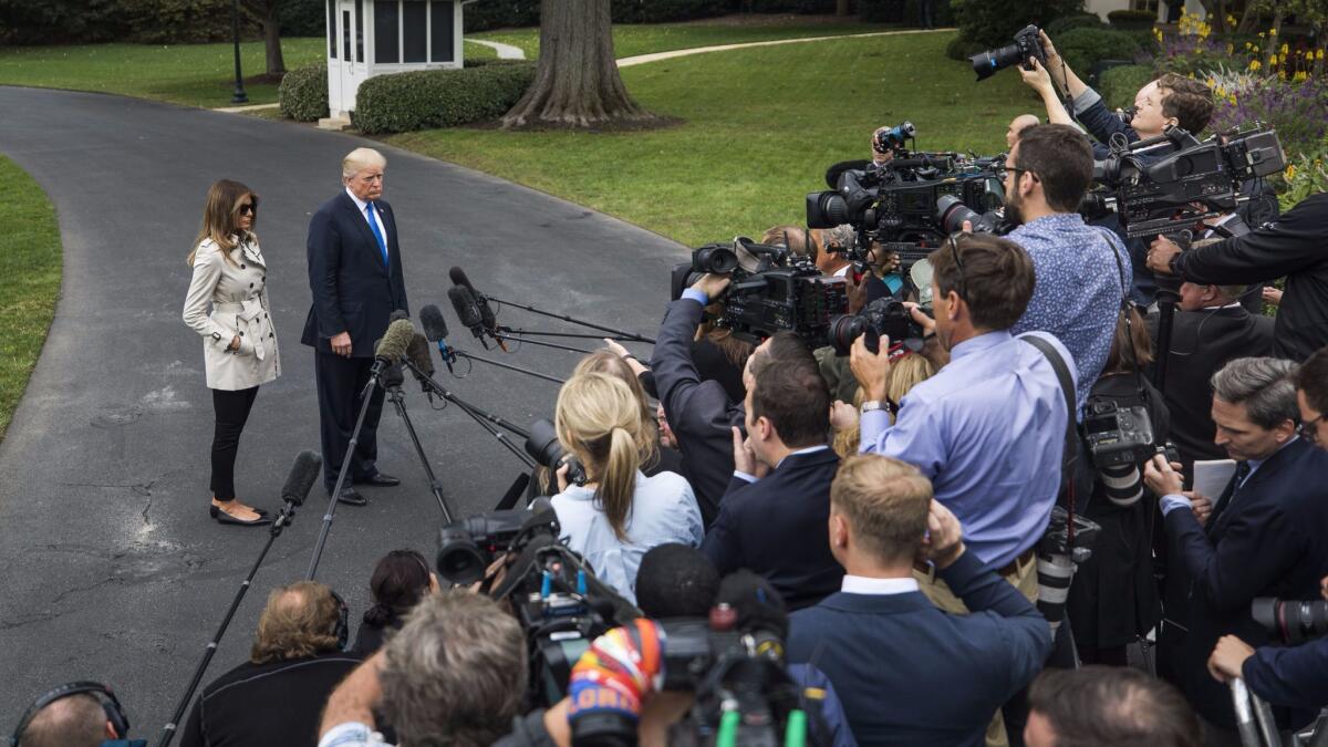 President Trump speaks to journalists on the south lawn of the White House on Oct. 13.