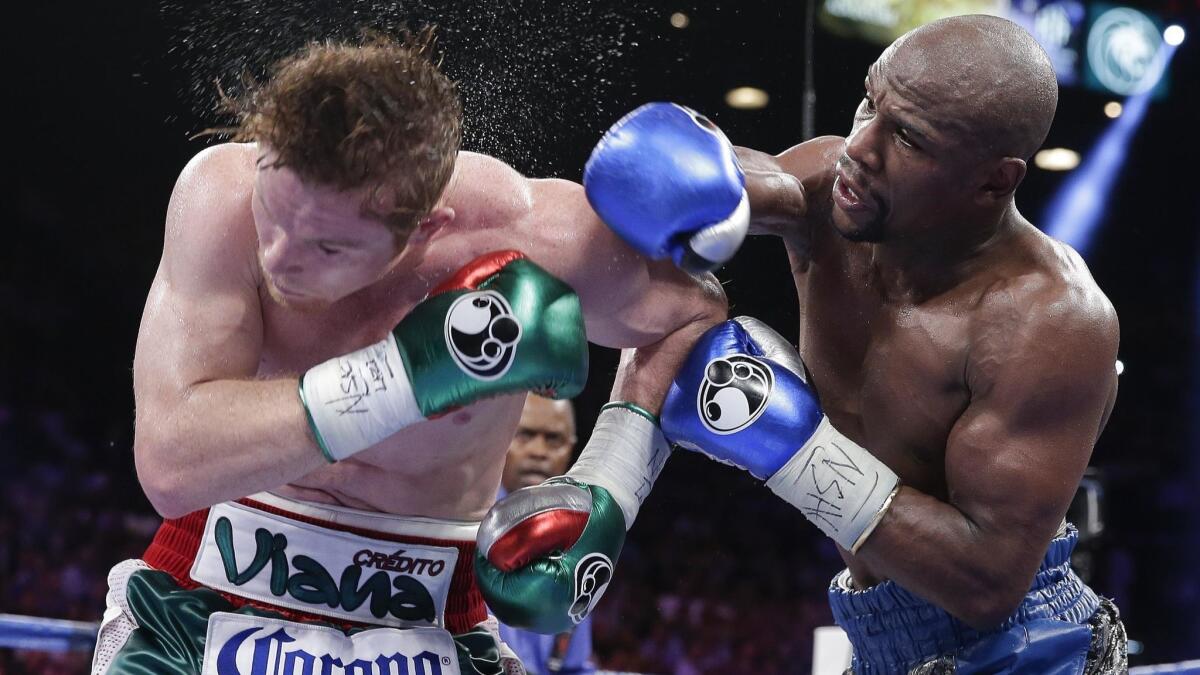 Floyd Mayweather Jr. lands a punch against Canelo Alvarez during their Sept. 2013 fight.