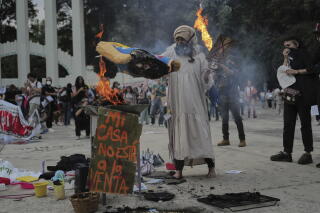 A demonstrator burns an effigy of U.S. President Trump in Parque Mexico.