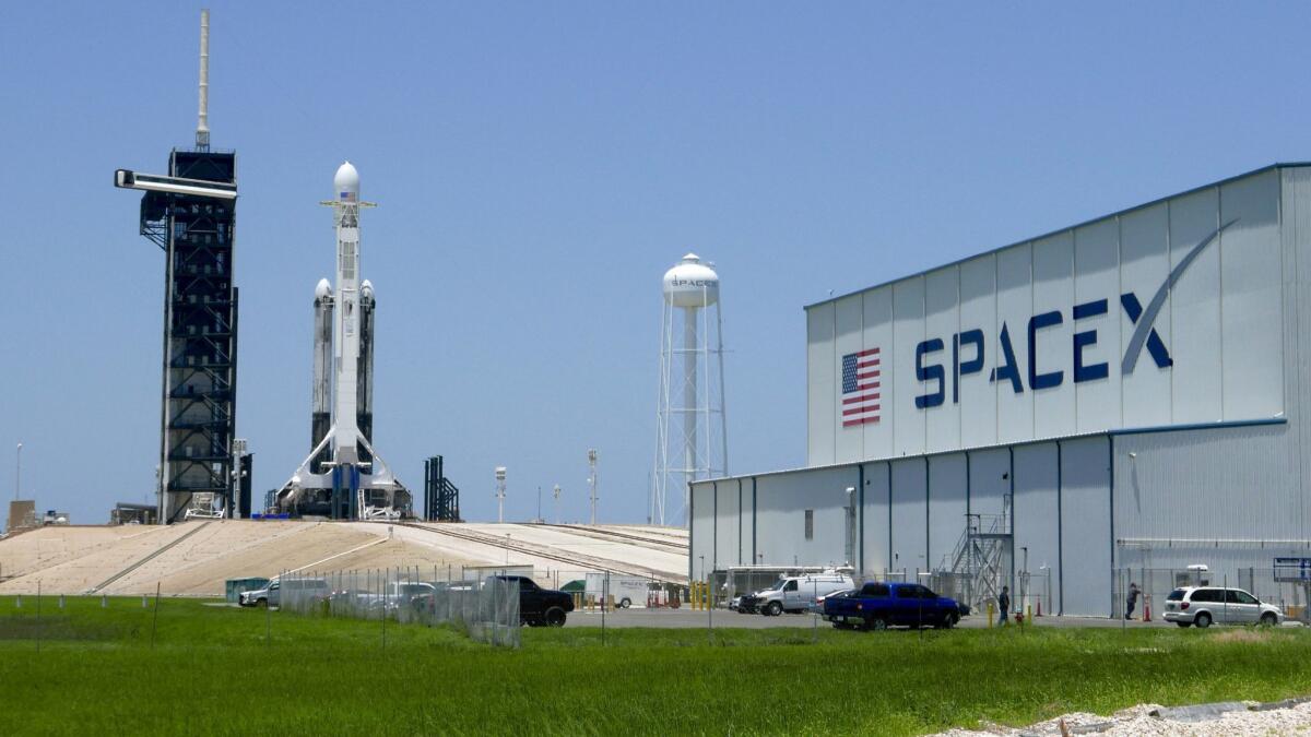 A SpaceX Falcon heavy rocket stands ready for launch at the Kennedy Space Center in Cape Canaveral, Fla., in June. Monday's fire was at a different facility.