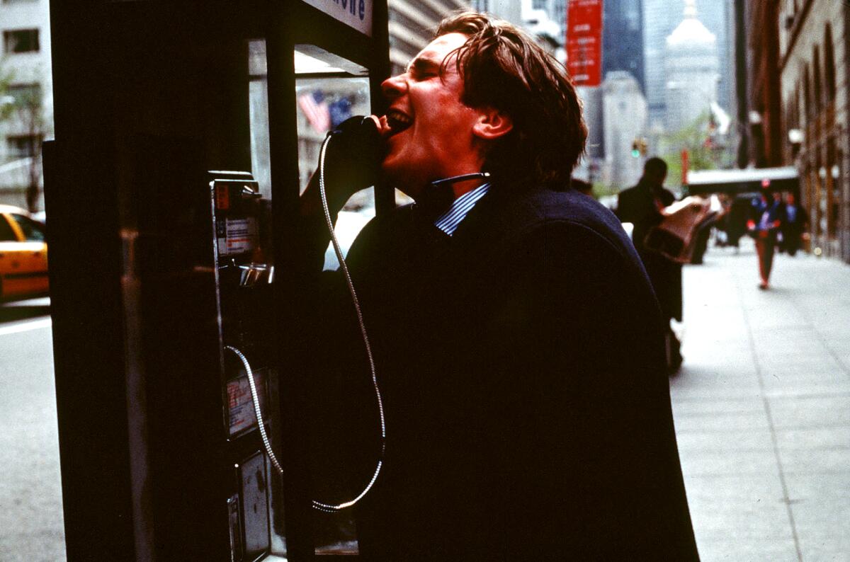 A bloody man at a pay phone on a New York street