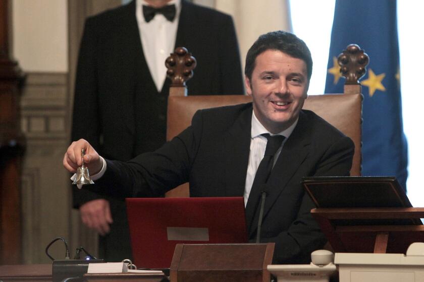 Italy's new Prime Minister Matteo Renzi rings the bell to open his first Cabinet meeting on Saturday in Rome. Renzi is the country's youngest ever prime minister.