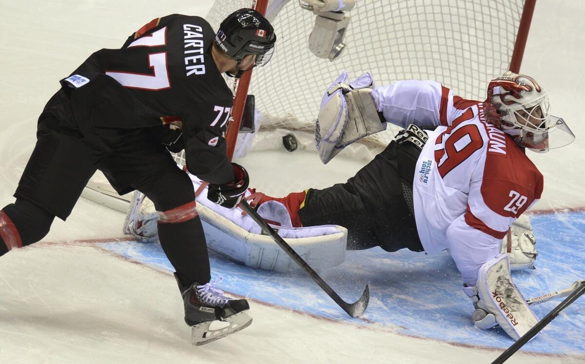 Kings winger Jeff Carter of Canada scores one of his three goals, beating goaltender Bernhard Starkbaum, during the Canadians' 6-0 rout of Austria on Friday at the Bolshoy Arena.