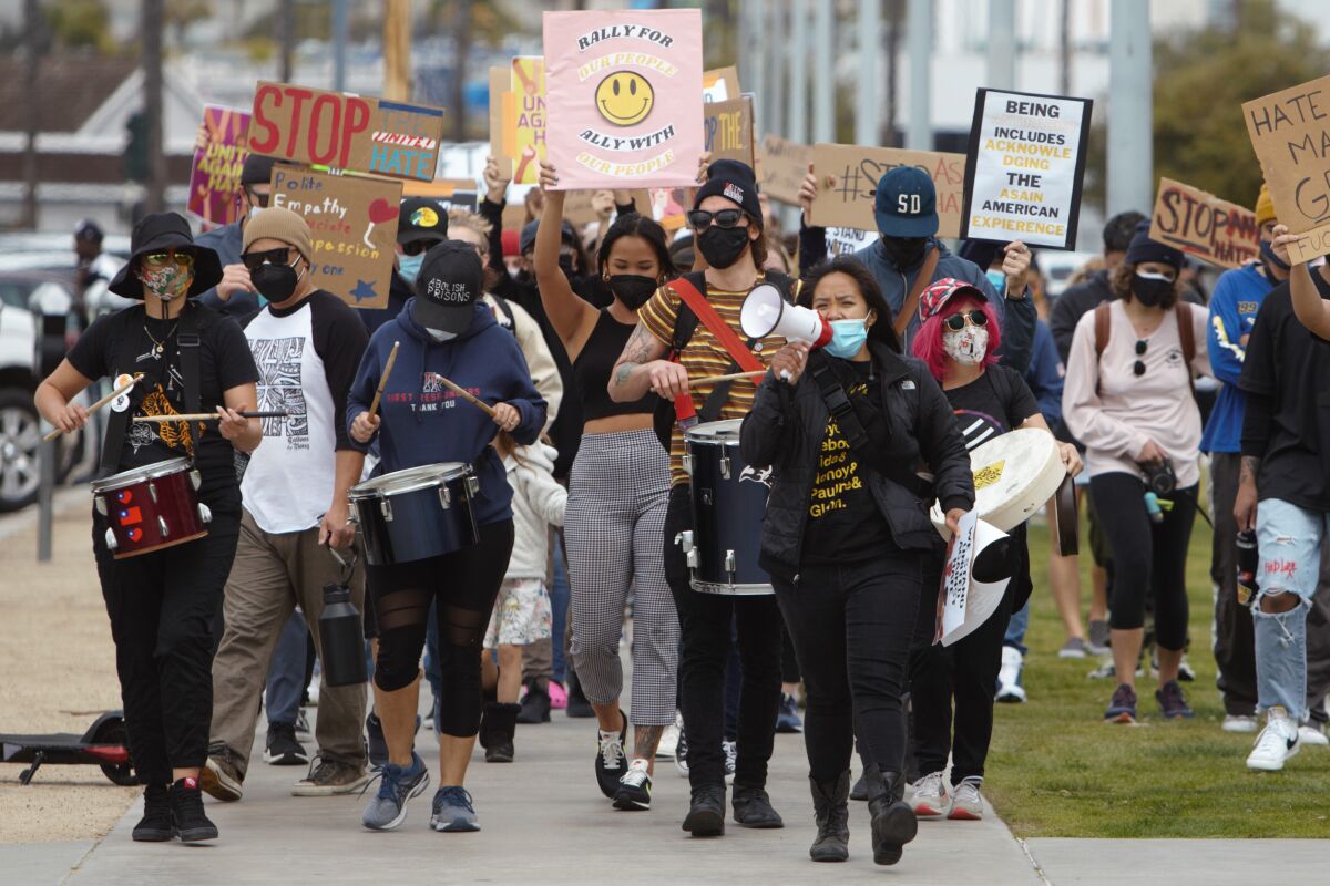Nearly 100 people participate in a Stop Asian Hate rally, marching along Harbor Drive in San Diego on Saturday
