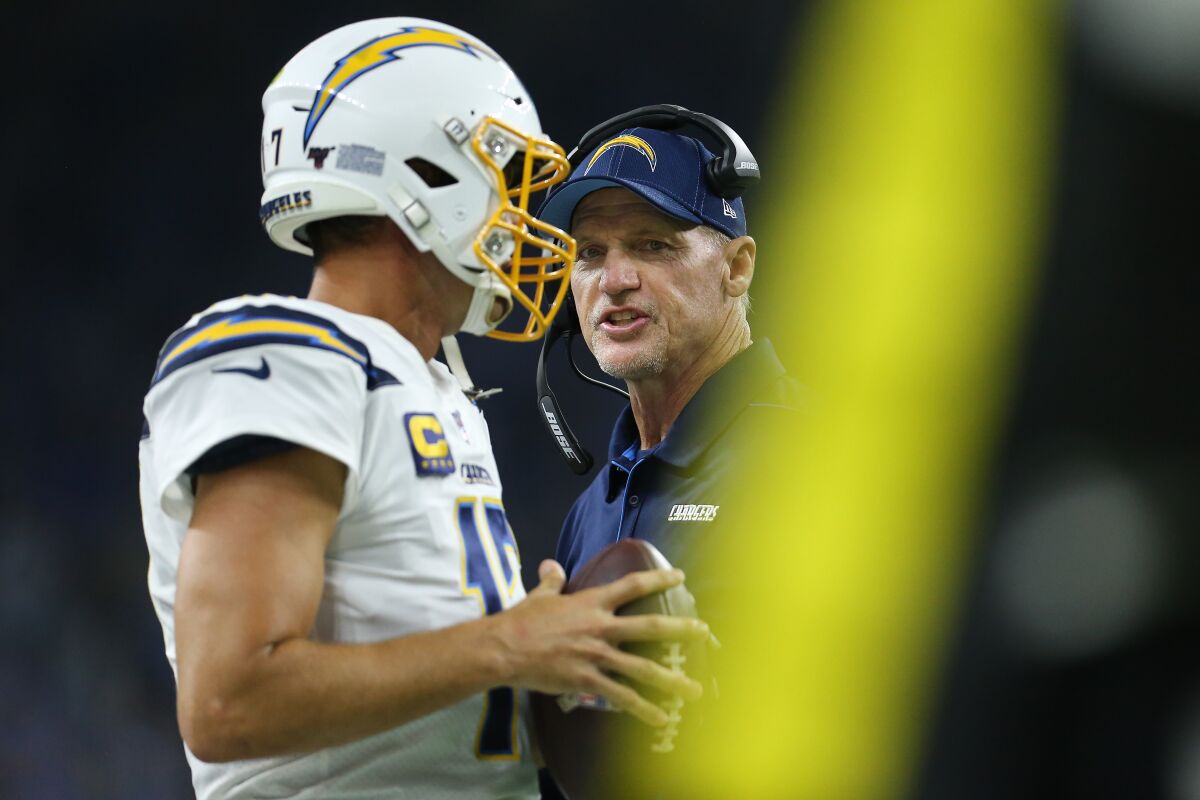 Chargers offensive coordinator Ken Whisenhunt talks to quarterback Philip Rivers during a loss to the Detroit Lions on Sept. 15.