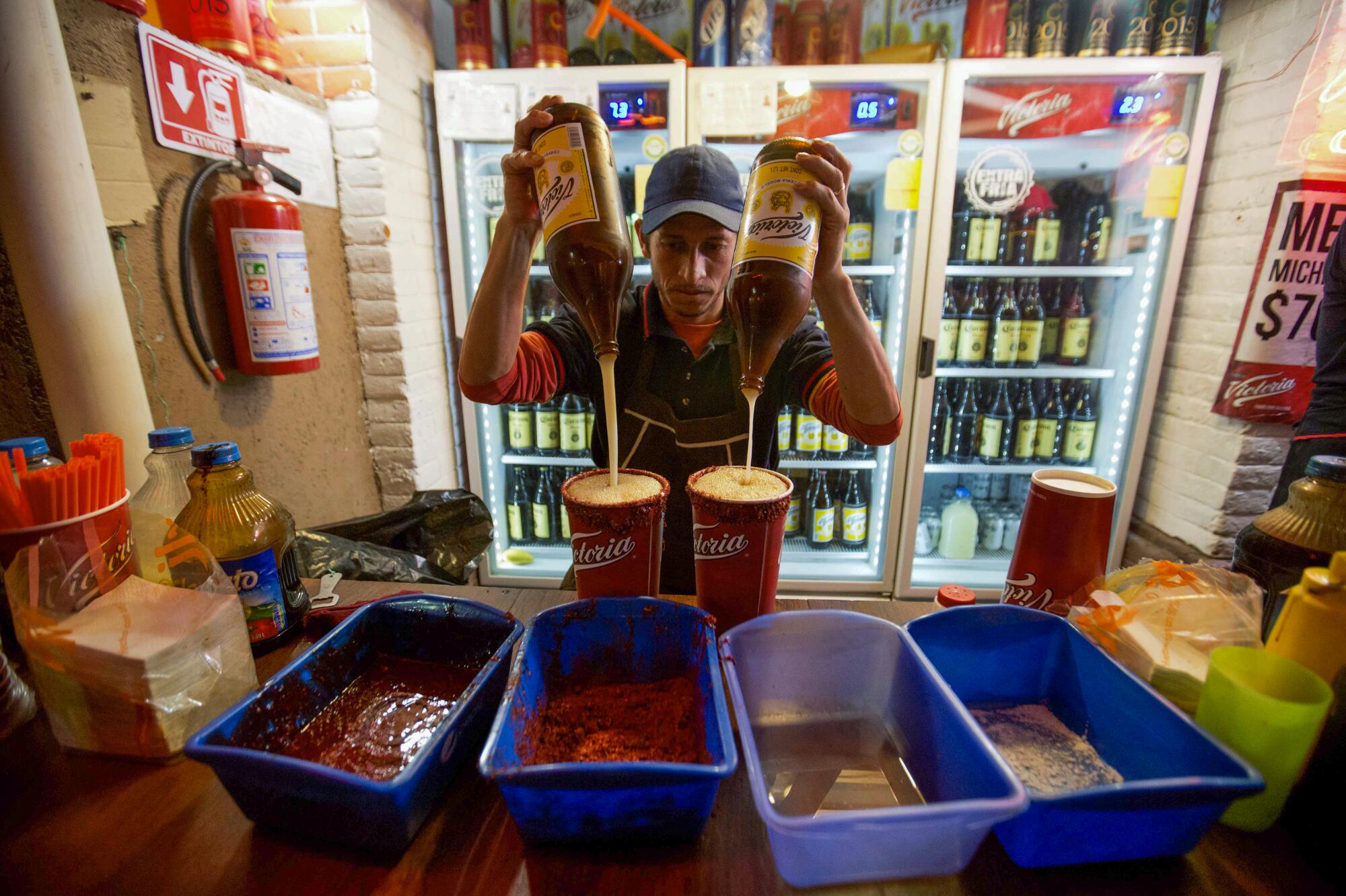 A vendor prepares micheladas at the Texcoco Fair.